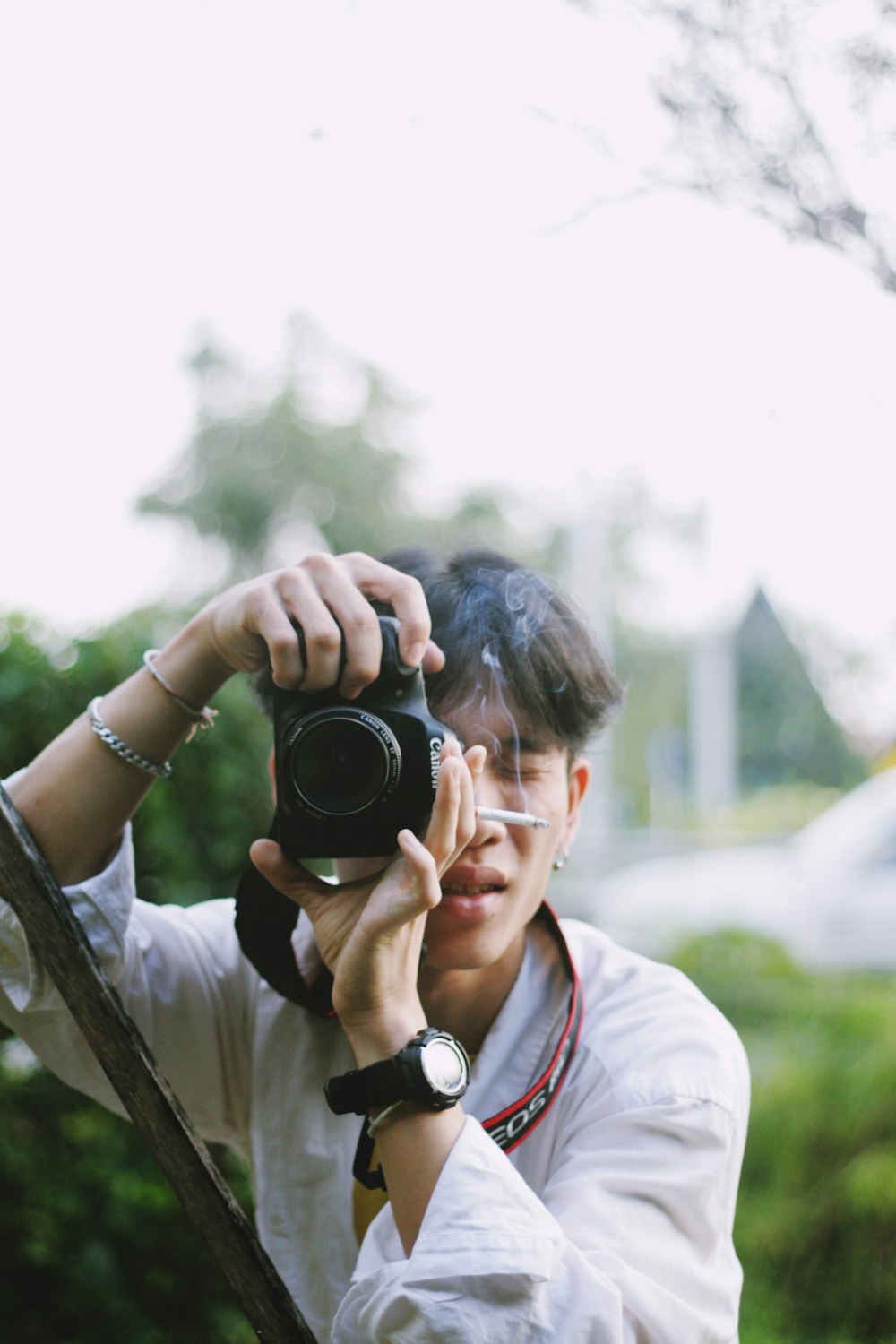 man holding black Canon camera during daytime