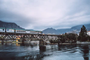 An irontruck branded truck crossing a bridge with mountains in the background