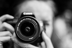 person taking photo using Canon camera in shallow focus lens
