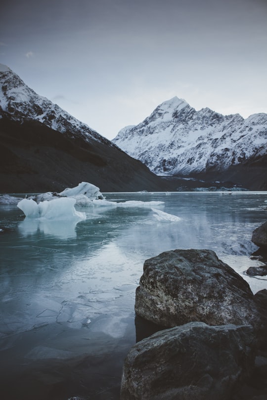 mountain beside body of water in Hooker Valley track New Zealand