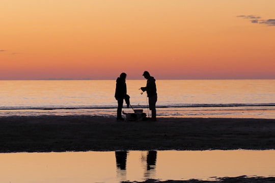 silhouette of two persons on shore in Semaphore Beach Australia