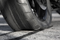 A close-up of a motorcycle's tire gripping the asphalt during a race.
