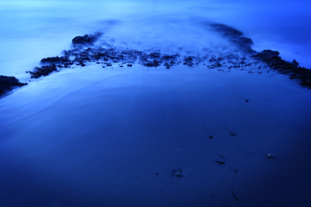 an aerial view of a blue ocean at night