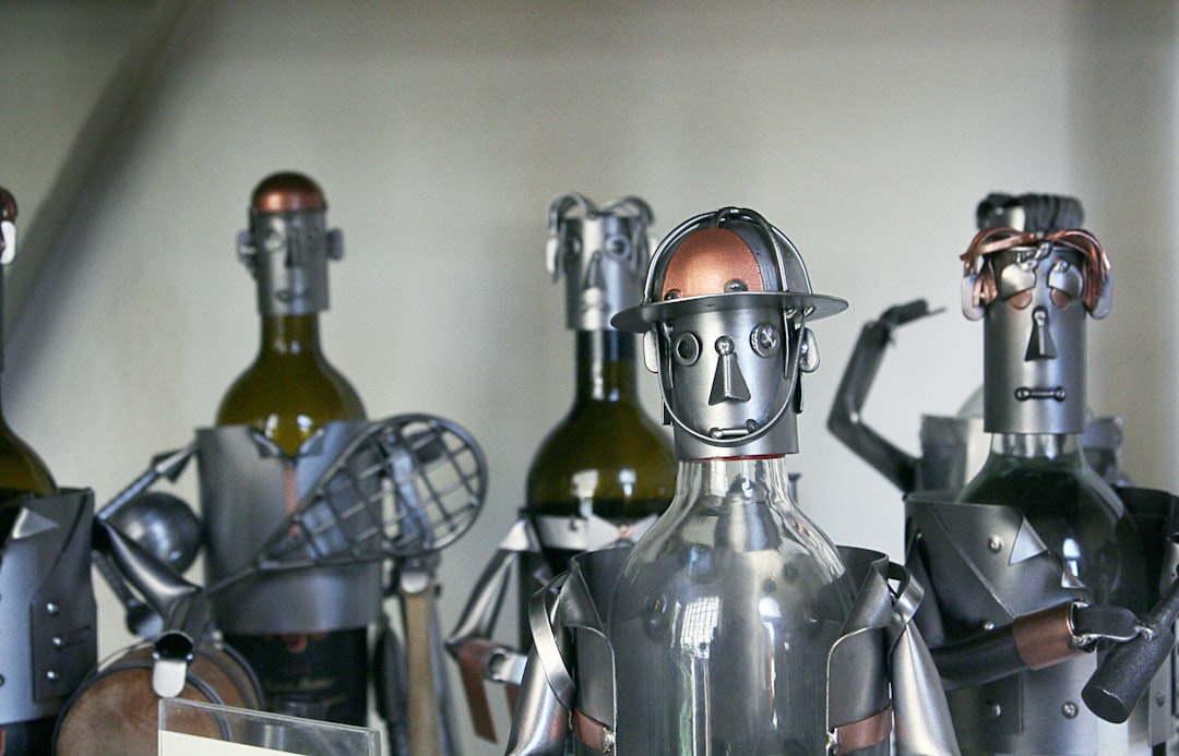 five gray-and-brown metal robots,
