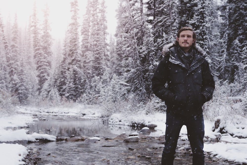 man in black jacket on swamp