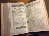 Close-up of the play’s script pages with handwritten notes and historical photos.