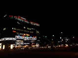 A commercial building with exterior lighting and signage.