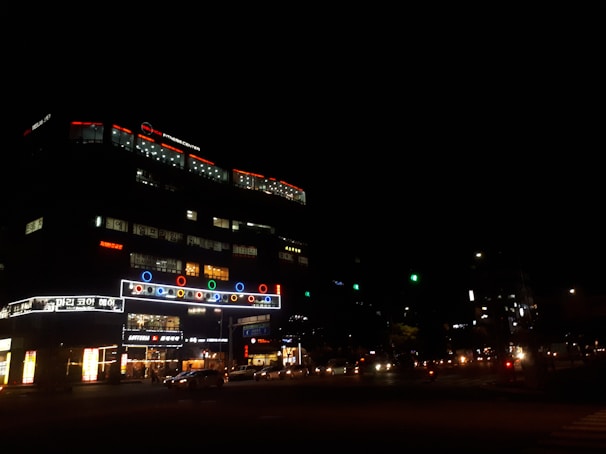 Outdoor advertising signs lit up during evening hours.