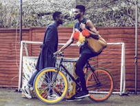 man holding brown bag riding bicycle