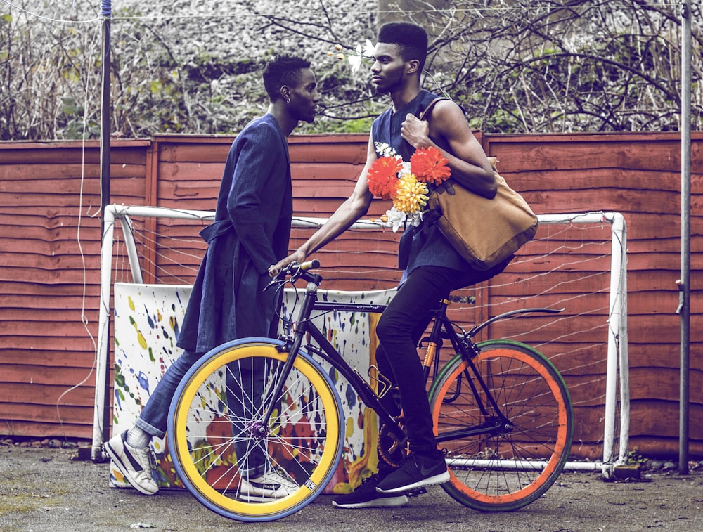 man holding brown bag riding bicycle