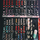 A display of rubber manicure tools and colorful polish bottles neatly arranged.