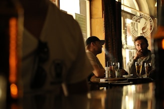 A thoughtful coach and supervisor engaged in a reflective conversation in a cozy, professional setting.