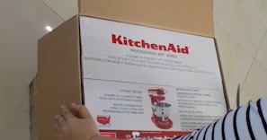 An influencer unboxing a gourmet kitchen gadget with an excited smile