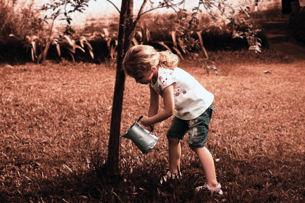 Muchacha regando el árbol