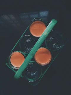 Top view of an array of colorful natural juices in small glasses, arranged neatly on a tray.