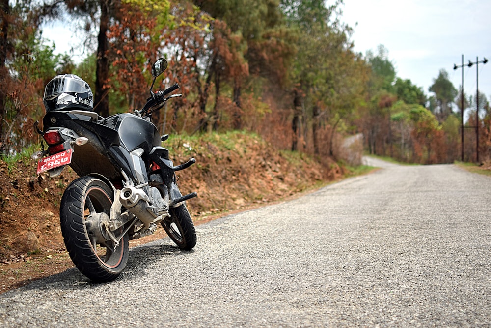 black full-face helmet on black naked motorcycle