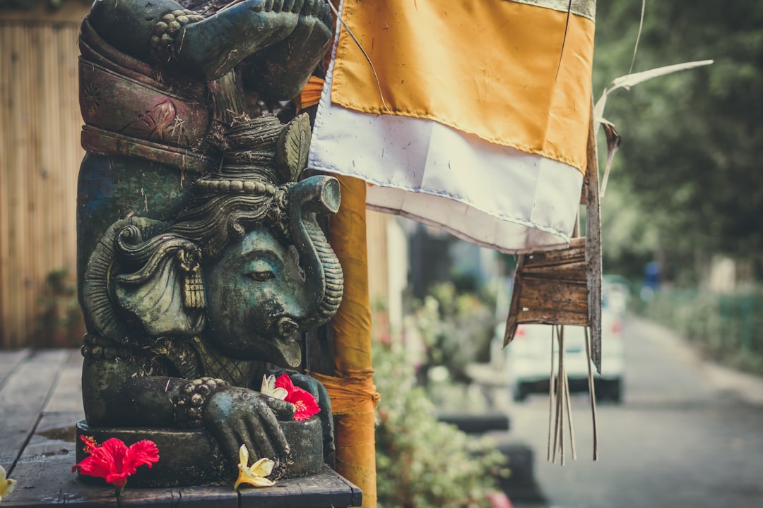 Ganesha statuette beside a flag