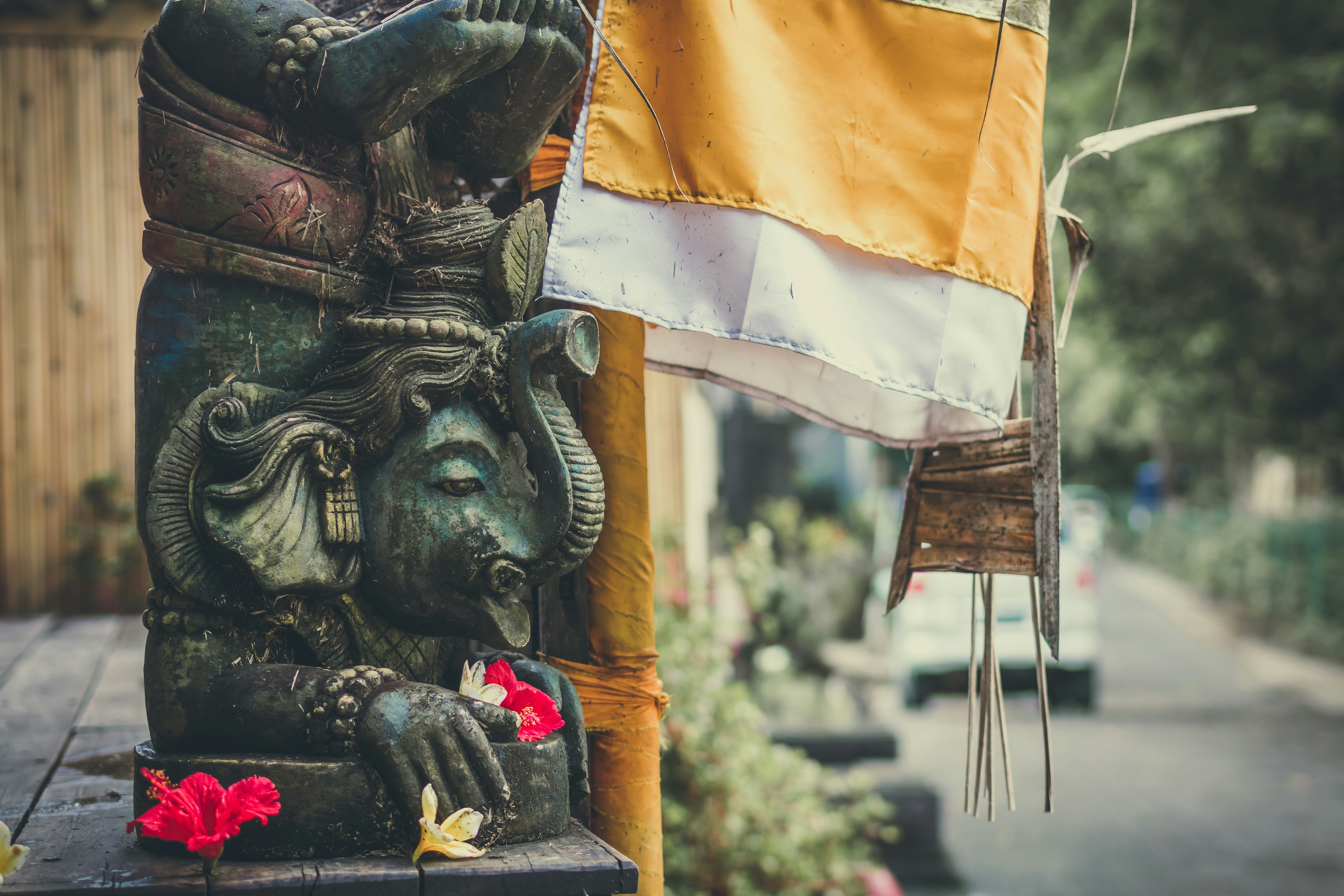 Ganesha statuette beside a flag