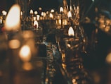 Warm candlelight flickering inside a rustic European inn, inviting quiet reflection.