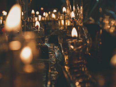 Warm candlelight flickering inside a rustic European inn, inviting quiet reflection.