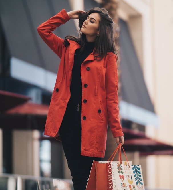 woman holding a paper bag walking on street