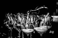 A calm, spacious composition showing a set of refined wine glasses next to a wrapped gift.