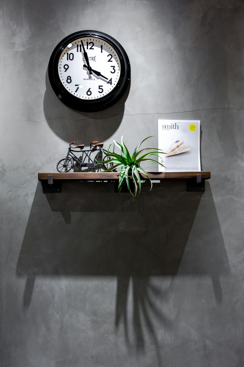 black and white analog wall clock displaying 3:58