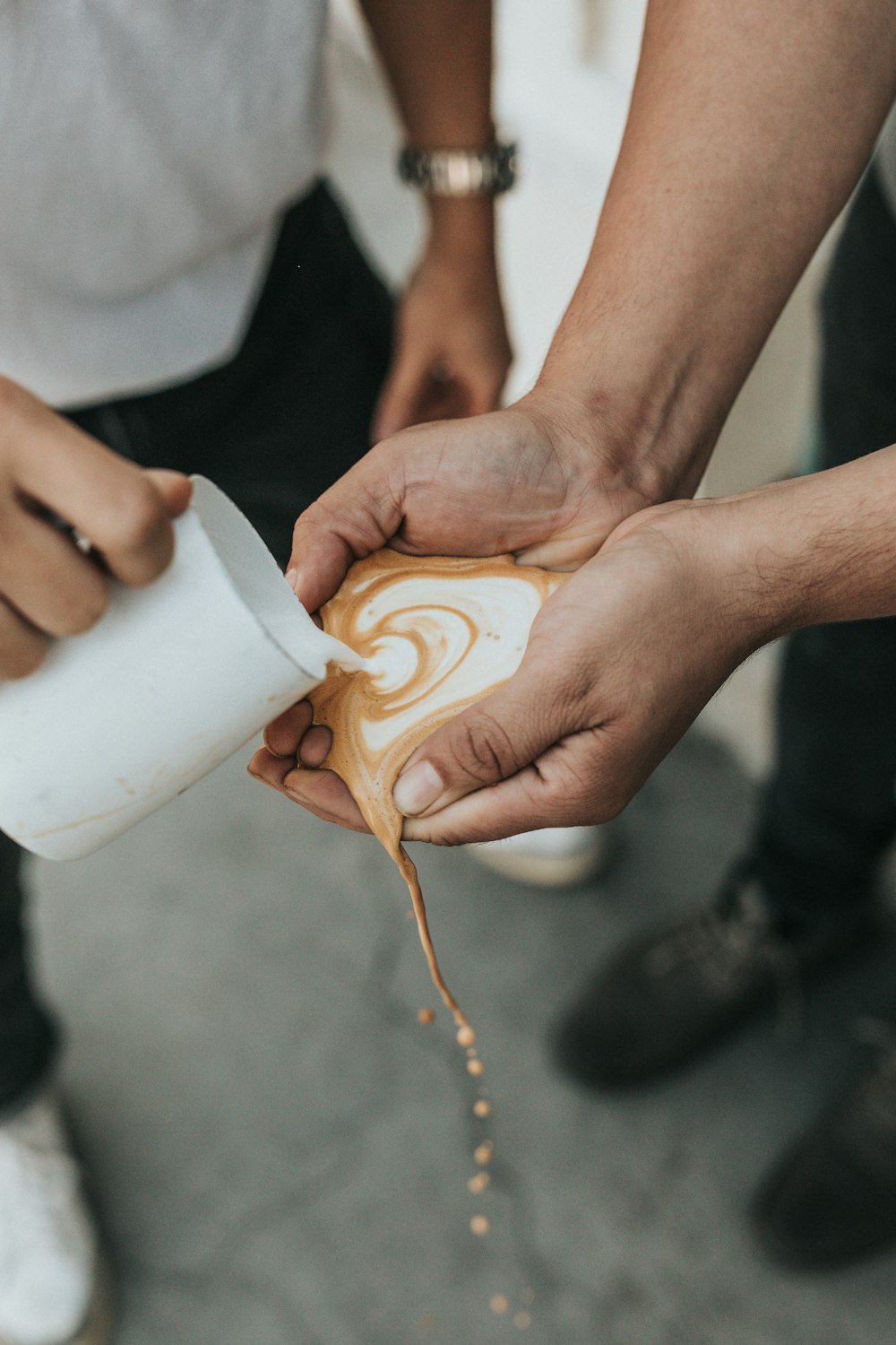 white and brown liquid poured on person's palms