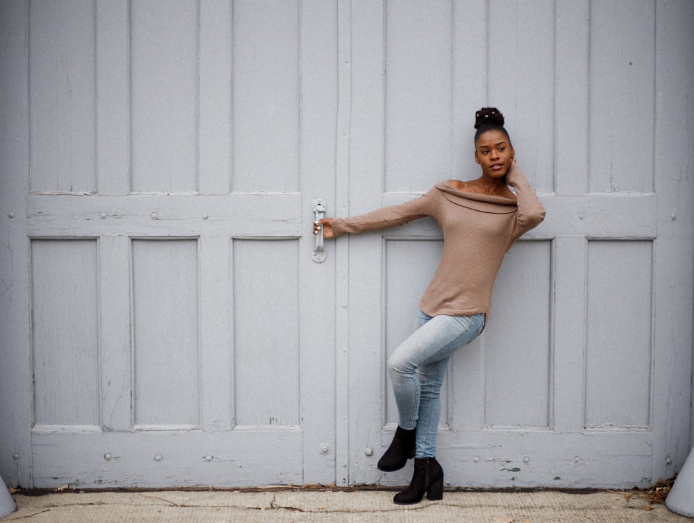 woman standing beside white door