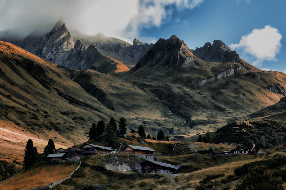 brown and gray house near mountain during daytime