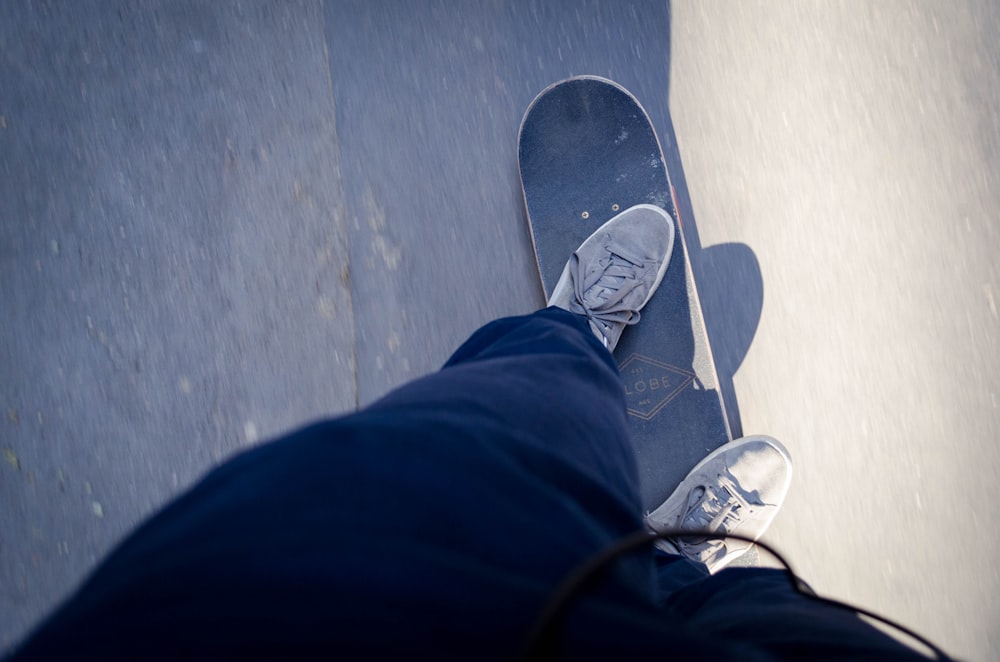 person standing black skateboard