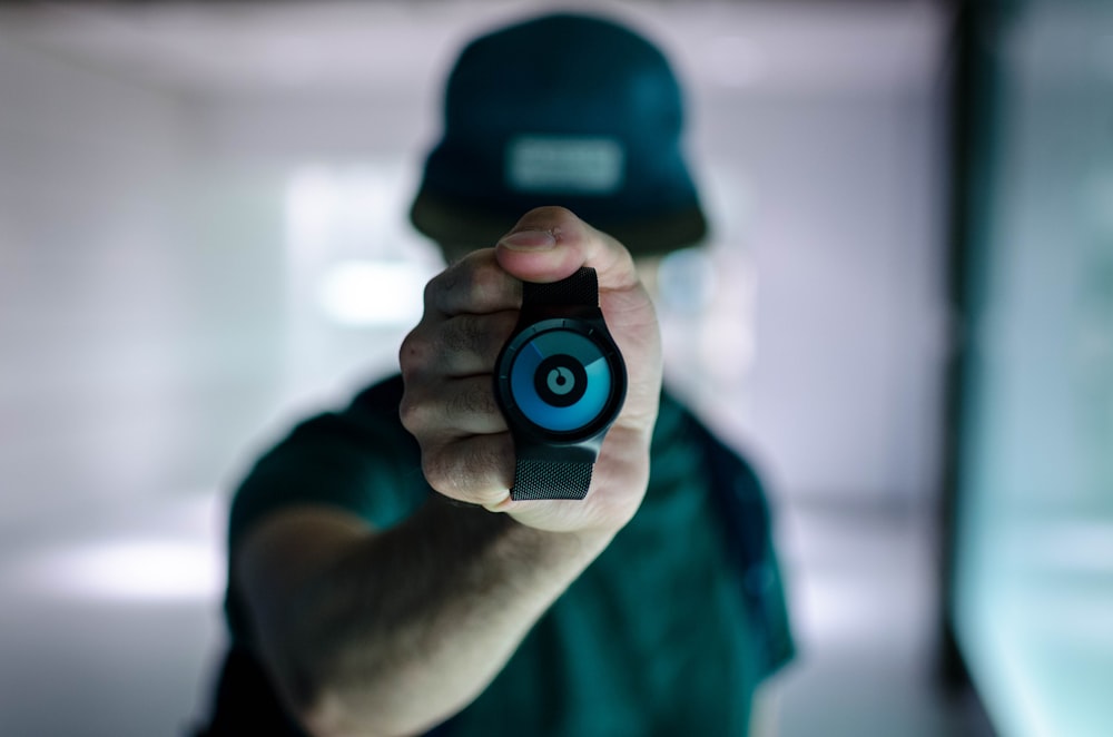 man holding black Ziiiro watch