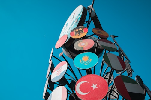 Flags from various countries arranged in a circle to represent worldwide cooperation.