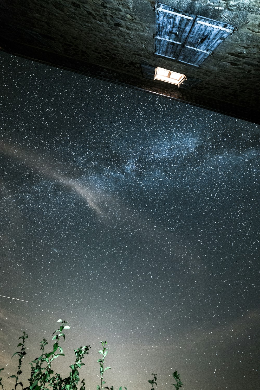 low angle photo of gray building under stargazing phenomenon