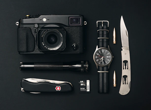 Close-up of tactical gear neatly arranged on a rugged surface, highlighting durability and quality.