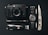A collection of everyday carry items is arranged neatly on a black surface. The items include a black camera with a lens, a classic watch with a NATO strap, a tactical folding knife, a Swiss Army knife, an ammunition bullet, a small flashlight, and a 64GB camera memory card.