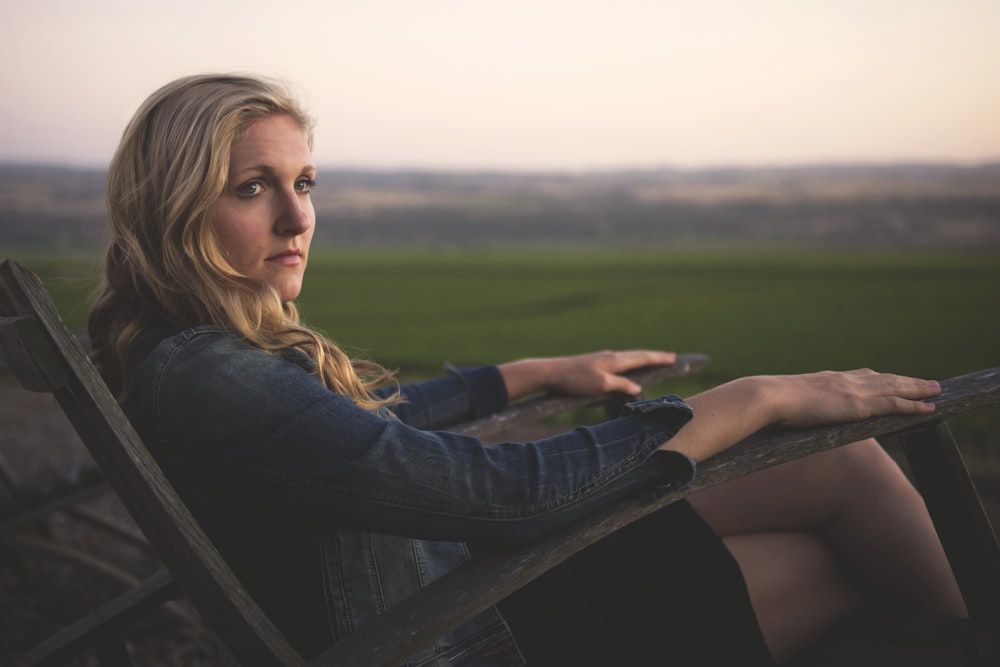 woman sitting on gray rocking armchair