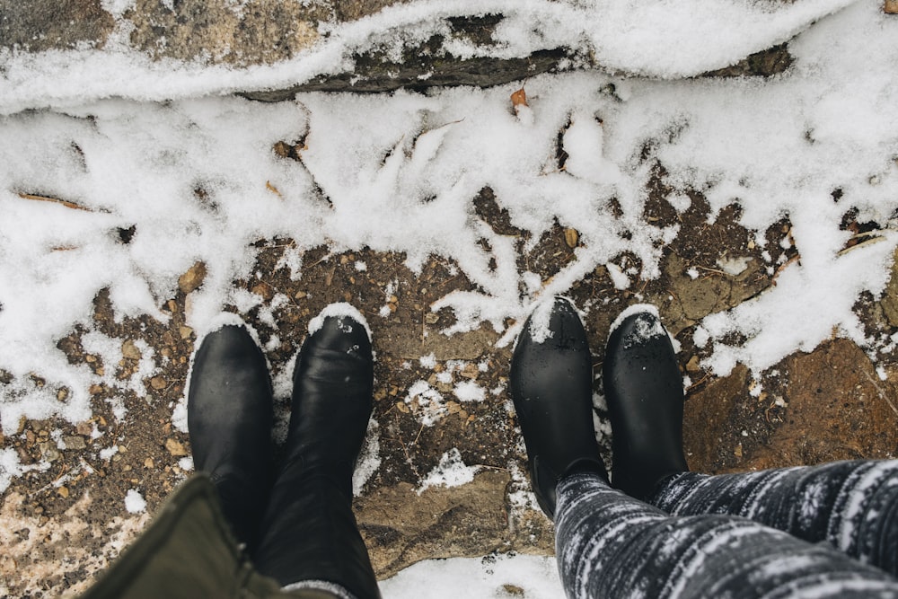 two person wearing black boots