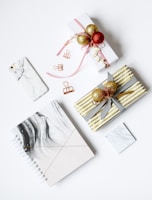 several assorted-color present boxes and notebook on table