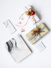several assorted-color present boxes and notebook on table