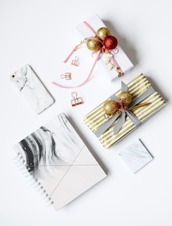 several assorted-color present boxes and notebook on table
