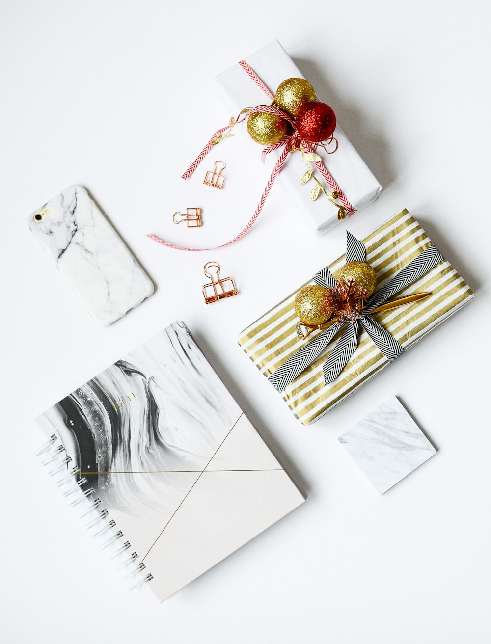 several assorted-color present boxes and notebook on table