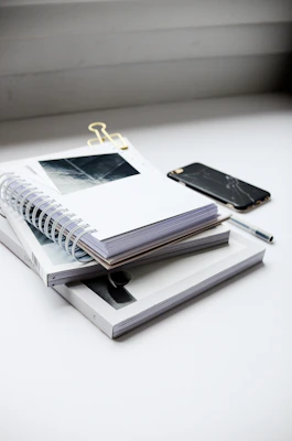 A neat stack of colorful study materials and notes arranged on a clean desk.
