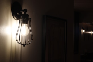 A stylish LED wall sconce illuminating a hallway.
