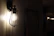 A cozy hallway softly lit by warm matte brass wall sconces from lumiara.