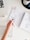 A close-up of a hand holding a pen over a planner.
