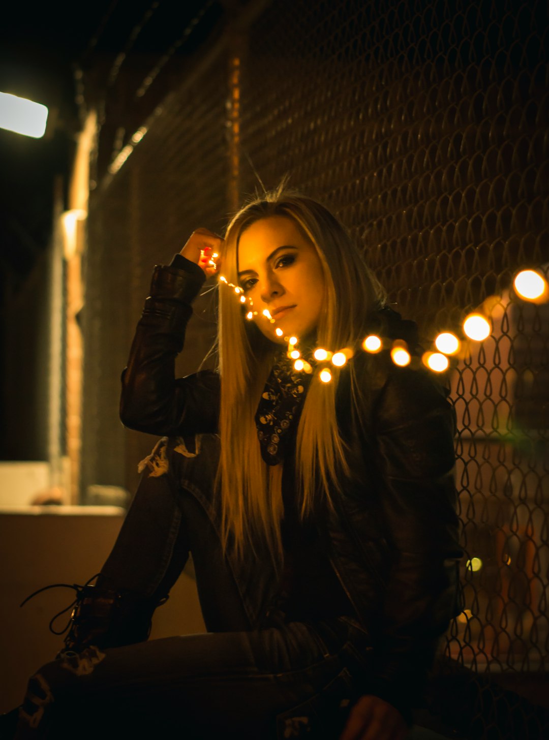 woman in black long-sleeved shirt holding string light