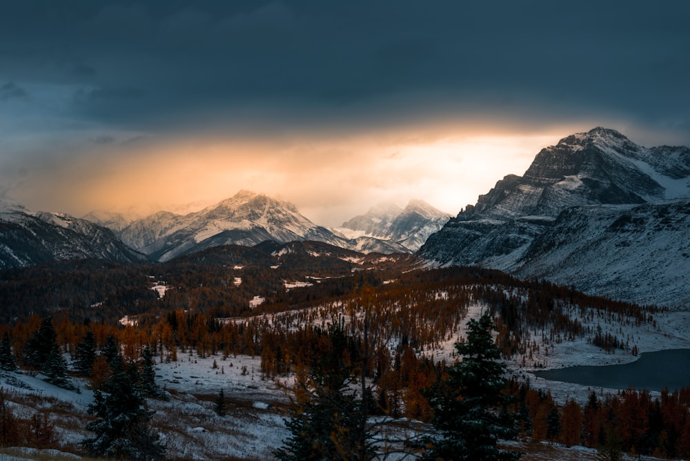 landscape photo of mountain covered with snow under cloudy sky