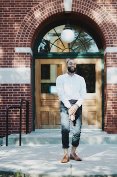 A confident lawyer standing in front of a law office.
