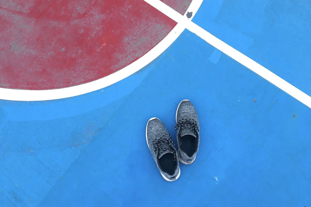 pair of blue shoes on ball court